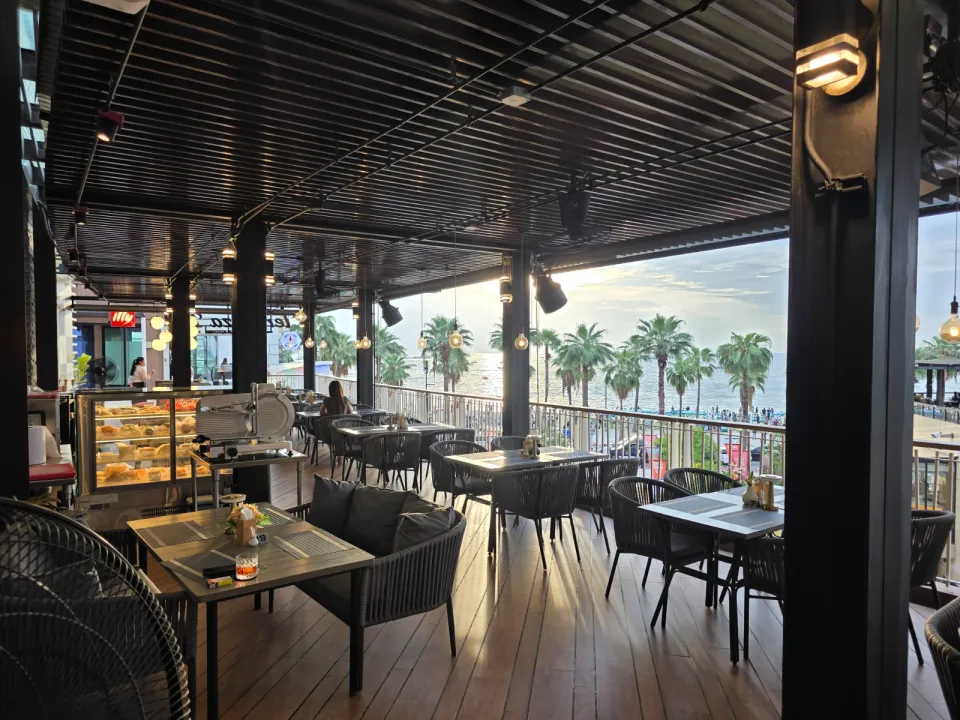 Sea-view terrace tables at Terrazza Baia during sunset